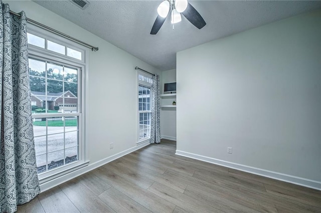 220 Chandler Ct, Sugar Hill, GA 30518 - spare room featuring wood finished floors, a ceiling fan, and a textured ceiling