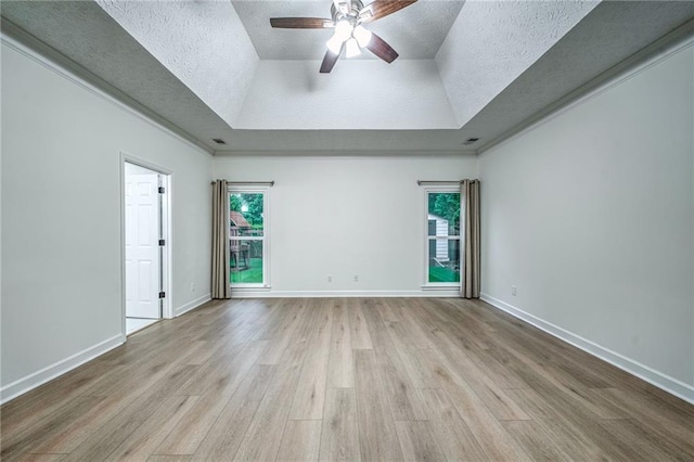 220 Chandler Ct, Sugar Hill, GA 30518 - unfurnished room featuring a raised ceiling, plenty of natural light, a textured ceiling, wood finished floors, and a ceiling fan