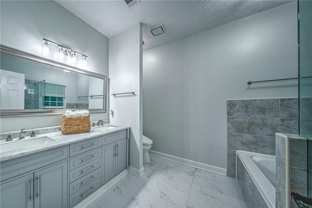 220 Chandler Ct, Sugar Hill, GA 30518 - full bath with double vanity, a garden tub, marble look tile flooring, and a textured ceiling