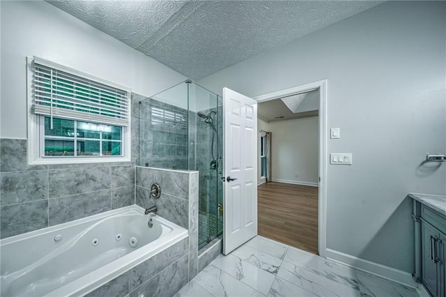 220 Chandler Ct, Sugar Hill, GA 30518 - bathroom featuring a jetted tub, a shower stall, vanity, marble look tile flooring, and a textured ceiling