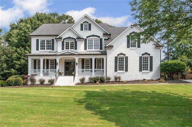 735 River Ridge Lane, Suwanee, GA 30024 - traditional home with covered porch, a standing seam roof, a front yard, and metal roof