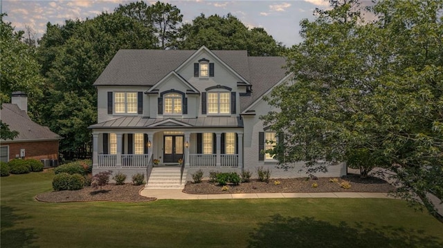 735 River Ridge Lane, Suwanee, GA 30024 - view of front of house with a porch, a standing seam roof, a front yard, french doors, and metal roof