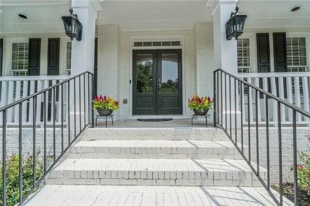 735 River Ridge Lane, Suwanee, GA 30024 - property entrance with french doors, brick siding, and covered porch