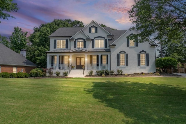 735 River Ridge Lane, Suwanee, GA 30024 - view of front of home with covered porch, a lawn, a standing seam roof, and metal roof