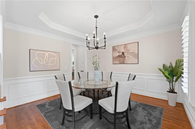 735 River Ridge Lane, Suwanee, GA 30024 - dining room featuring a chandelier, wood finished floors, a raised ceiling, crown molding, and a decorative wall