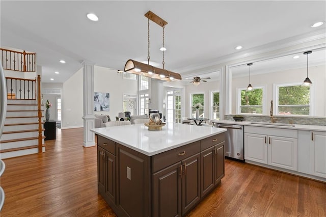 735 River Ridge Lane, Suwanee, GA 30024 - kitchen with dishwasher, a sink, light countertops, decorative columns, and a ceiling fan