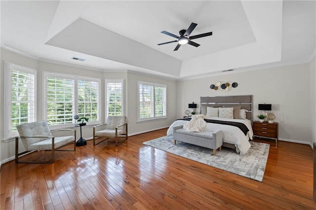 735 River Ridge Lane, Suwanee, GA 30024 - bedroom featuring a raised ceiling, multiple windows, hardwood / wood-style flooring, baseboards, and ornamental molding