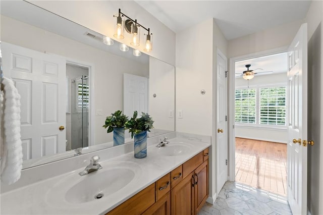 735 River Ridge Lane, Suwanee, GA 30024 - bathroom featuring double vanity, a shower with door, ceiling fan, and toilet