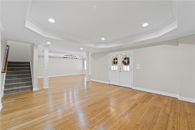 735 River Ridge Lane, Suwanee, GA 30024 - foyer entrance with decorative columns, a tray ceiling, ornamental molding, light wood-type flooring, and stairway