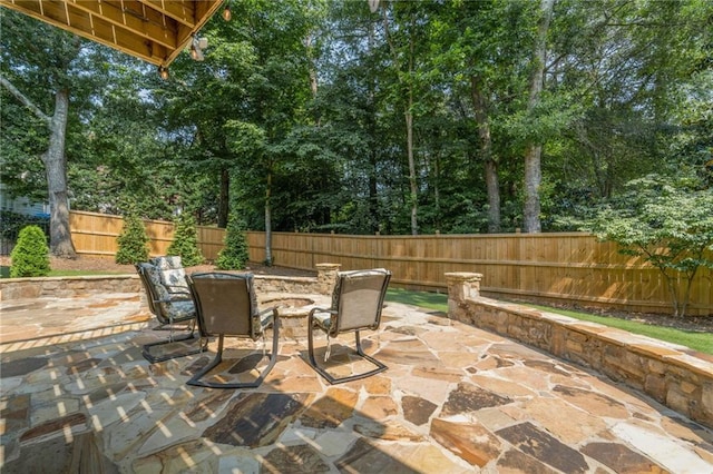 735 River Ridge Lane, Suwanee, GA 30024 - fenced backyard featuring a fire pit, a patio, and view of wooded area