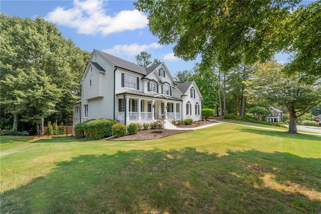 735 River Ridge Lane, Suwanee, GA 30024 - view of front facade with a porch, a front lawn, and stucco siding