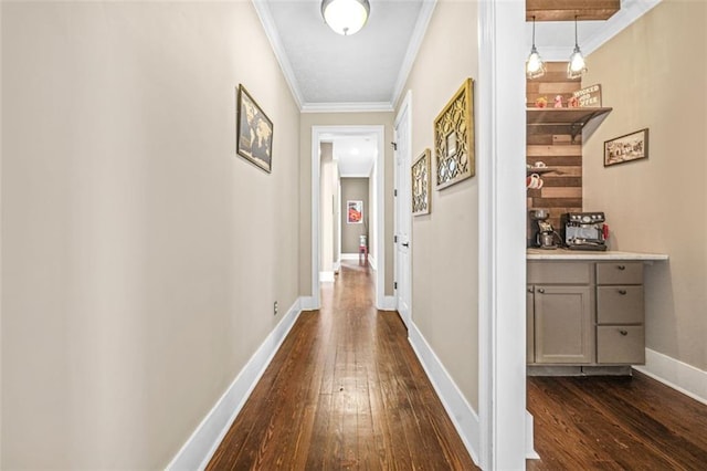 hall featuring dark wood-type flooring and ornamental molding