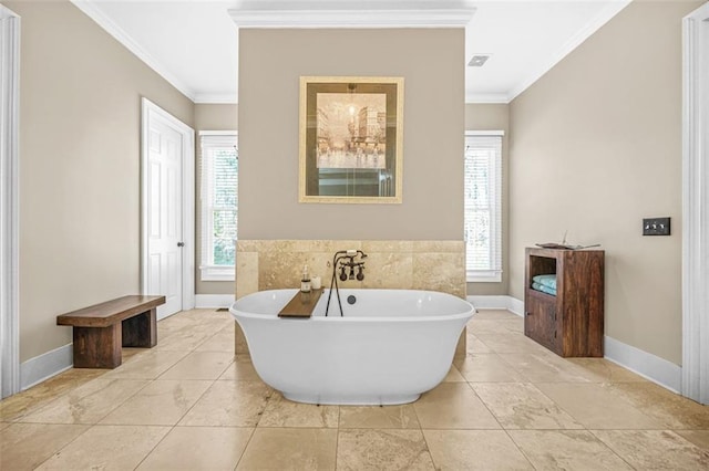 bathroom with ornamental molding and a tub