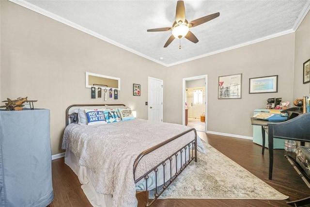 bedroom featuring ensuite bath, dark wood-type flooring, ornamental molding, and ceiling fan