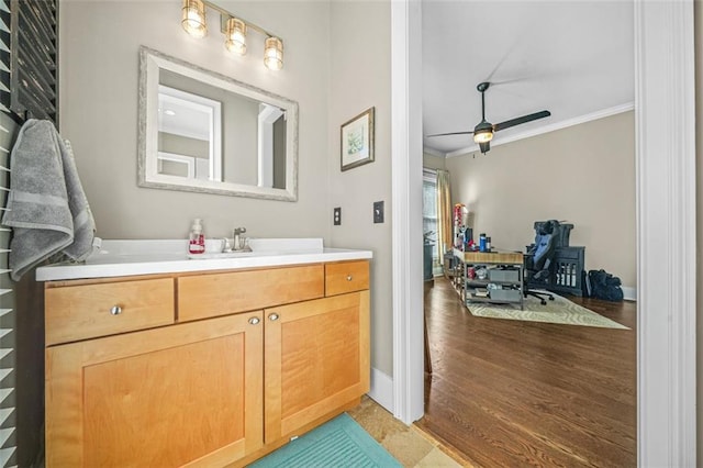 bathroom with vanity, ornamental molding, and ceiling fan