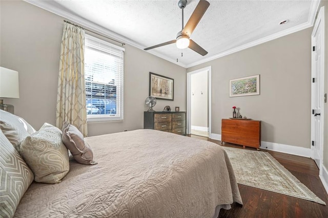 bedroom with a textured ceiling, dark wood-type flooring, ornamental molding, and ceiling fan