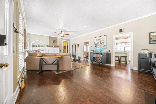 living room with dark hardwood / wood-style flooring, crown molding, and a textured ceiling