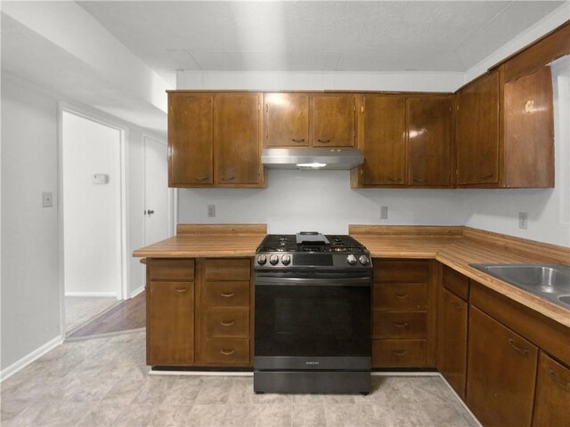 kitchen with a textured ceiling, sink, and black appliances