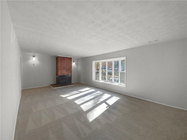 unfurnished living room with a fireplace, light carpet, and a textured ceiling