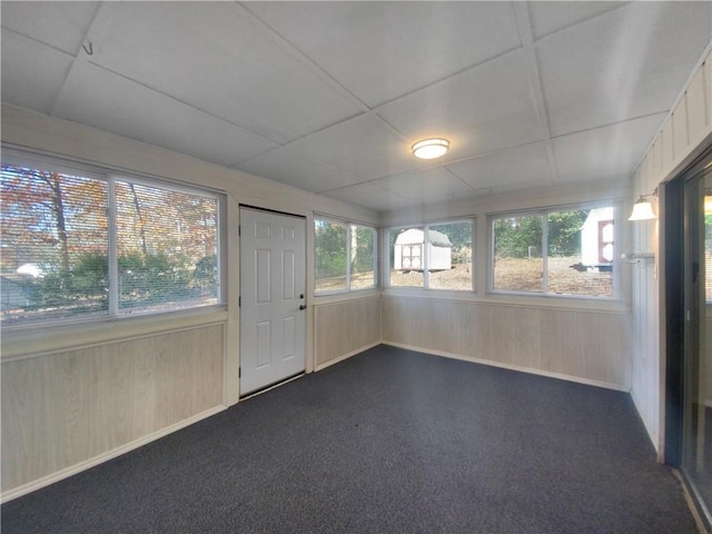 unfurnished sunroom with a wealth of natural light and a drop ceiling