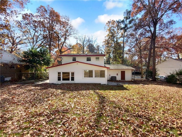 back of property featuring a yard and central AC unit