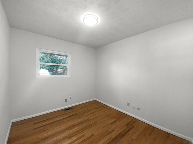 bedroom featuring hardwood / wood-style floors and a textured ceiling