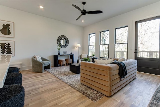 living room featuring ceiling fan and light wood-type flooring