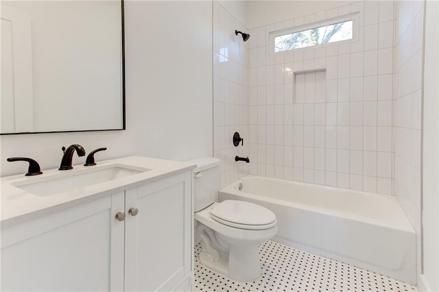 full bathroom with toilet, tiled shower / bath, and vanity