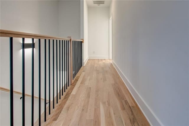 hall with light hardwood / wood-style floors