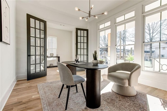 dining room featuring an inviting chandelier and light hardwood / wood-style flooring