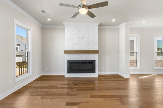 175 Basil St, Cumming, GA 30040 - unfurnished living room with wood finished floors, crown molding, a fireplace, ceiling fan, and recessed lighting
