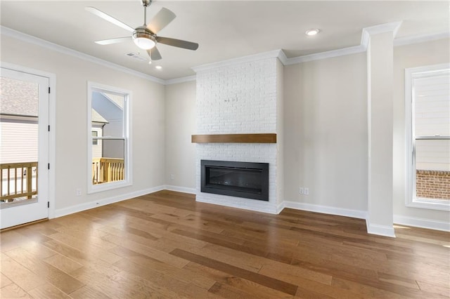 175 Basil St, Cumming, GA 30040 - unfurnished living room featuring hardwood / wood-style flooring, a brick fireplace, ornamental molding, a ceiling fan, and recessed lighting