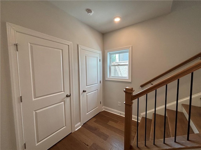 interior space with stairs, baseboards, recessed lighting, and dark wood-style flooring