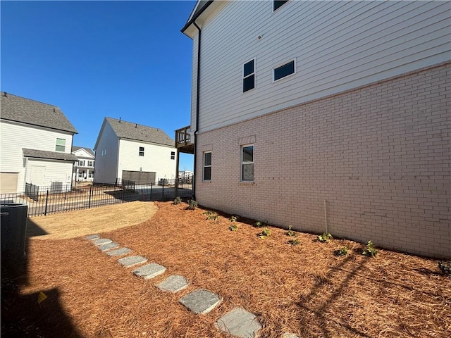 exterior space with brick siding and fence