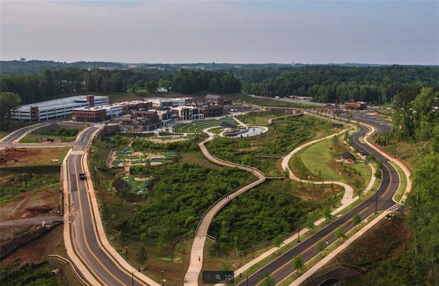 drone / aerial view featuring a wooded view