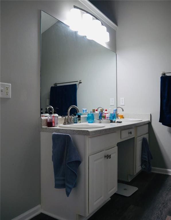 2350 Laurel Pointe Ln, Lawrenceville, GA 30043 - bathroom featuring double vanity, baseboards, and wood finished floors