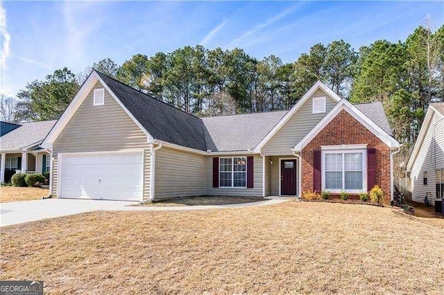 2350 Laurel Pointe Ln, Lawrenceville, GA 30043 - view of front of home featuring an attached garage, driveway, a front lawn, and brick siding