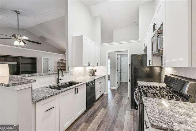 2350 Laurel Pointe Ln, Lawrenceville, GA 30043 - kitchen with range with gas cooktop, a sink, black dishwasher, white cabinetry, and high vaulted ceiling