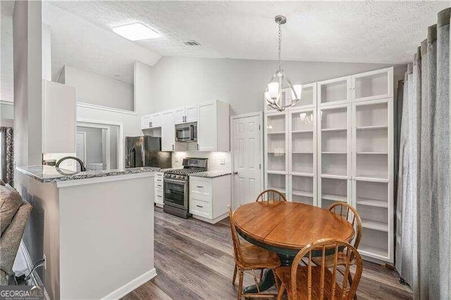 2350 Laurel Pointe Ln, Lawrenceville, GA 30043 - kitchen featuring stainless steel appliances, a textured ceiling, white cabinets, dark wood-style flooring, and a chandelier