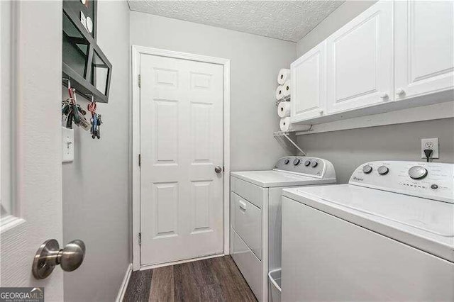 2350 Laurel Pointe Ln, Lawrenceville, GA 30043 - laundry area with cabinet space, washer and dryer, dark wood-style flooring, a textured ceiling, and baseboards