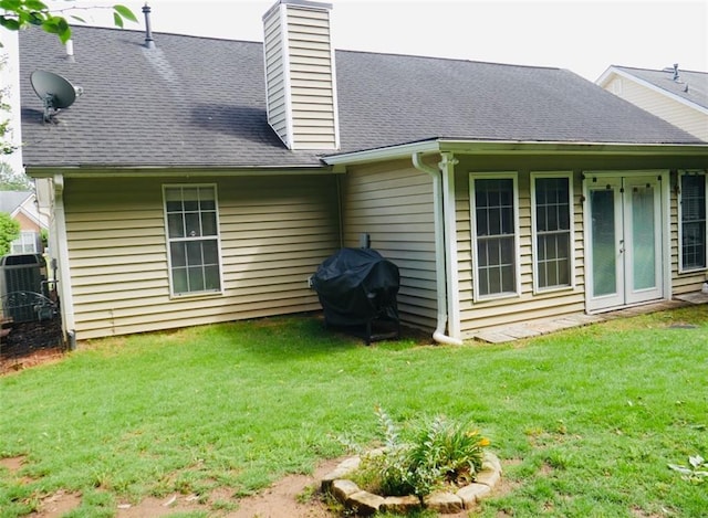 2350 Laurel Pointe Ln, Lawrenceville, GA 30043 - back of property with a lawn, central AC unit, a chimney, and a shingled roof