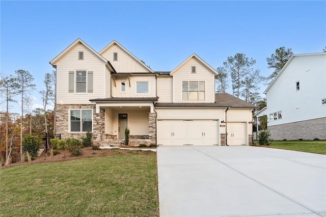 view of front of home with a front yard and a garage