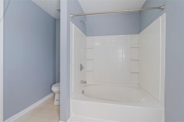 bathroom featuring tile patterned flooring, tub / shower combination, a textured ceiling, and toilet