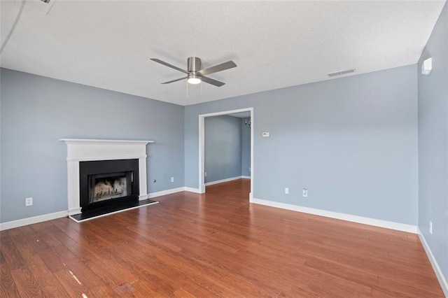 unfurnished living room featuring wood-type flooring and ceiling fan