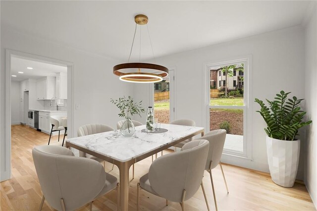 dining space featuring recessed lighting and light wood-style flooring