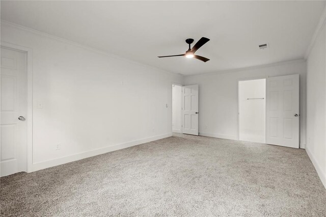 unfurnished bedroom featuring crown molding, baseboards, and carpet flooring