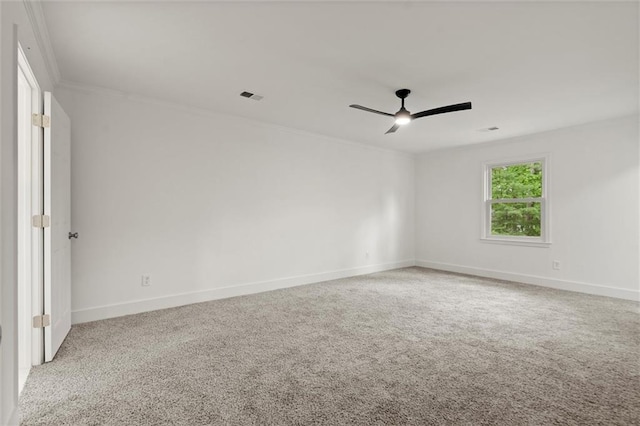 unfurnished room with carpet floors, ceiling fan, ornamental molding, and baseboards