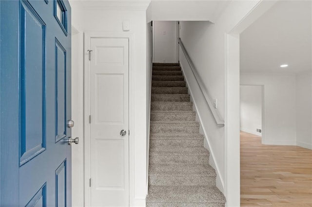 staircase with recessed lighting, baseboards, and wood finished floors