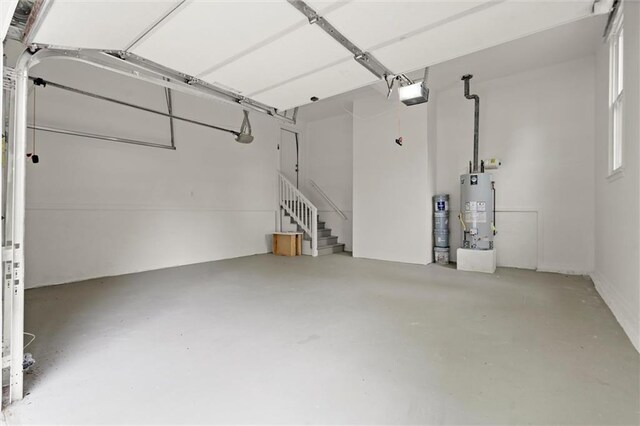 garage with a garage door opener and gas water heater
