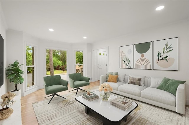 living area with recessed lighting and light wood-style flooring